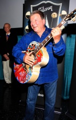 William Shatner clowns around with a special painted guitar presented to him by Gibson and Mandy Lawson