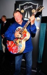 William Shatner clowns around with a special painted guitar presented to him by Gibson and Mandy Lawson