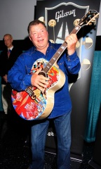 William Shatner clowns around with a special painted guitar presented to him by Gibson and Mandy Lawson